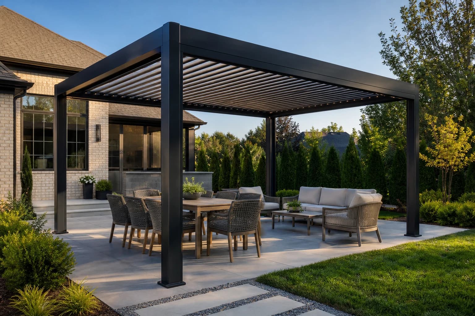 Large dark aluminum louvered pergola sized for separate dining and lounge areas on a Charlotte-area patio
