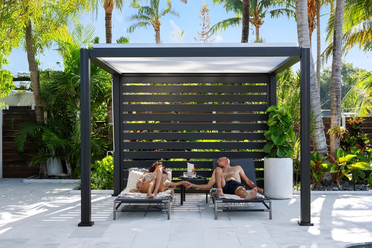 K-BANA freestanding louvered pergola with white louvers beside a pool