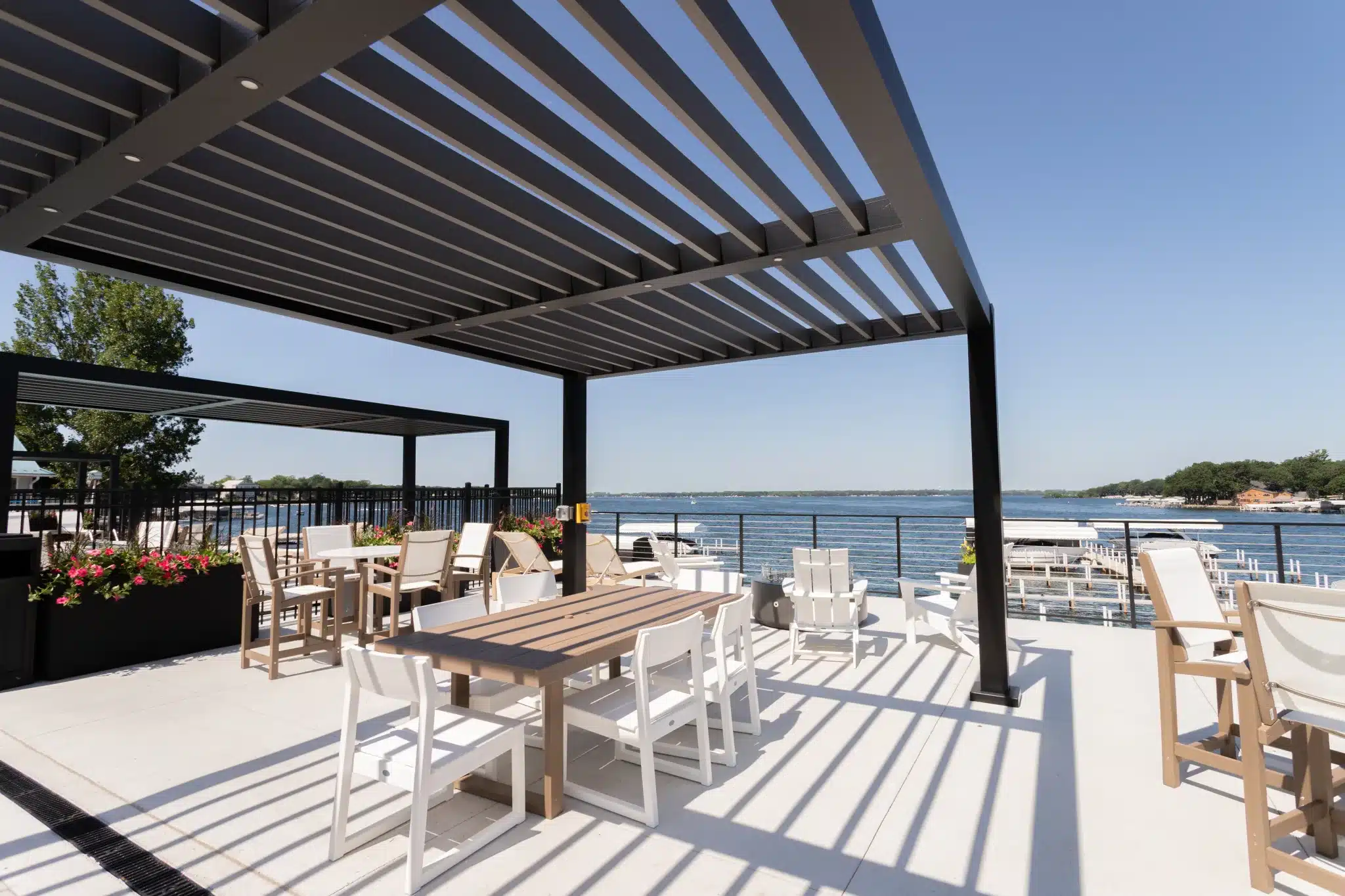 R-BREEZE fixed louvered pergola over an outdoor dining and pool area