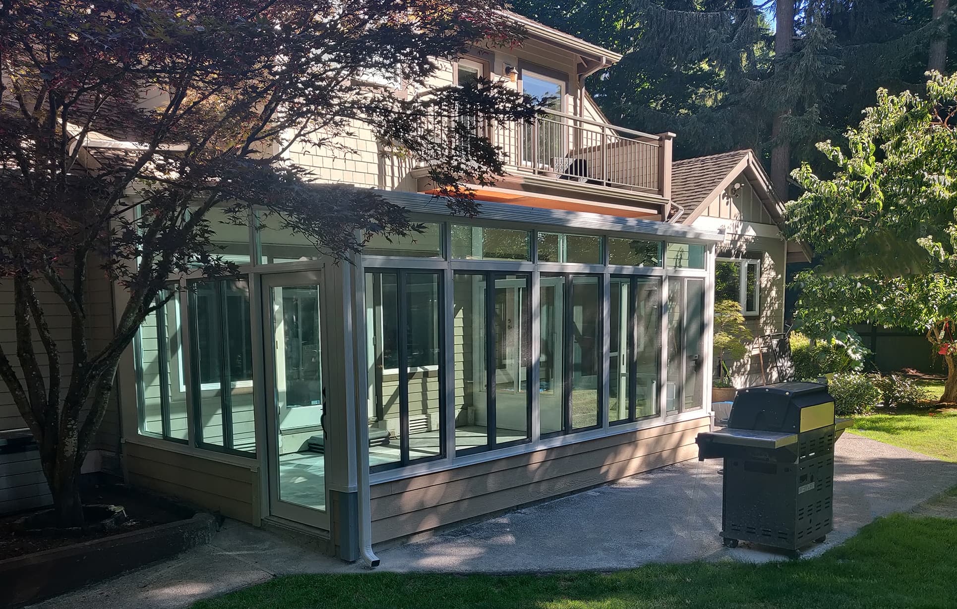 Solid roof sunroom with insulated roof panels on a home exterior